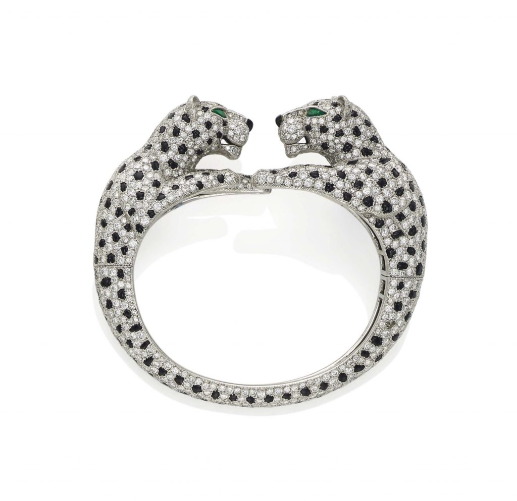 A CARTIER DIAMOND AND ONYX DOUBLE PANTHER HEAD BANGLE